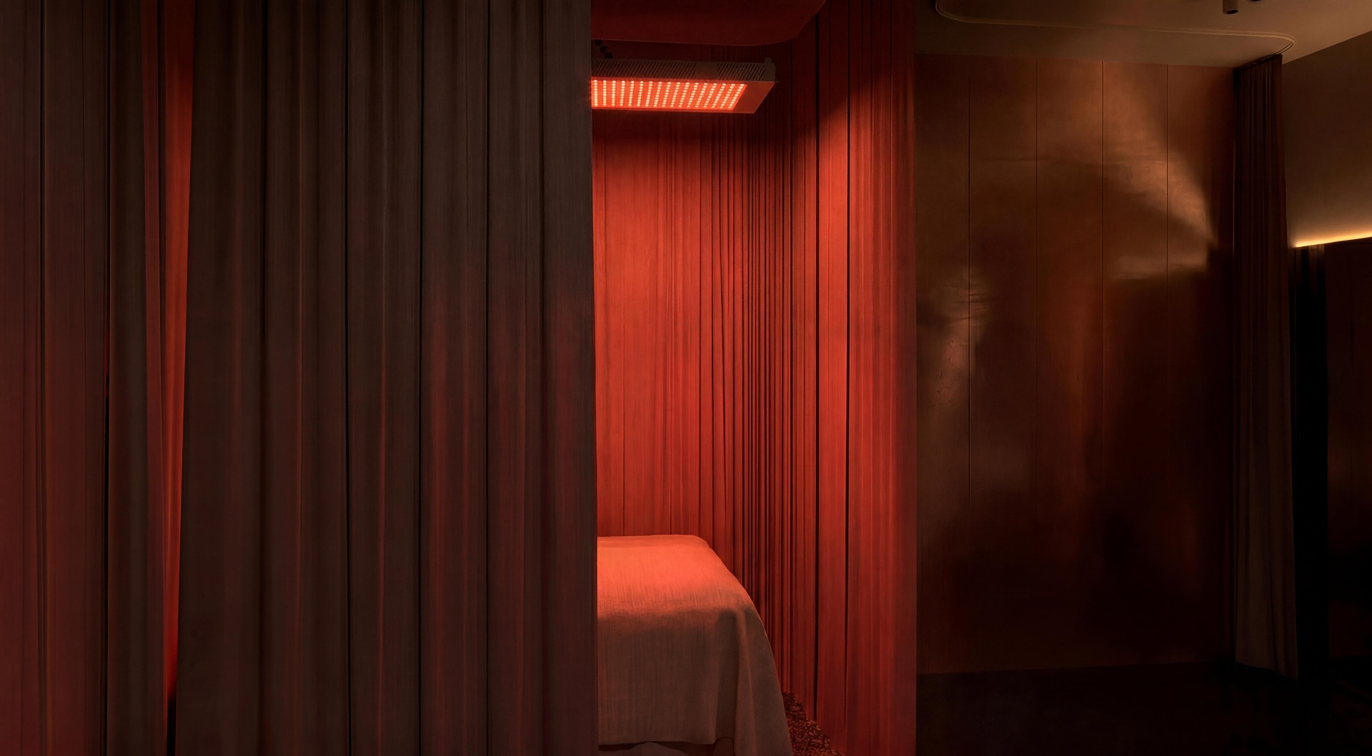 Red light therapy treatment room with linen curtains